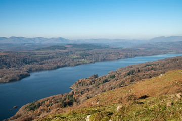 Fototapeta na wymiar Stuning vibrant Autumn Fall landscape image of view from Gummers How down onto Derwent Wter in Lake District