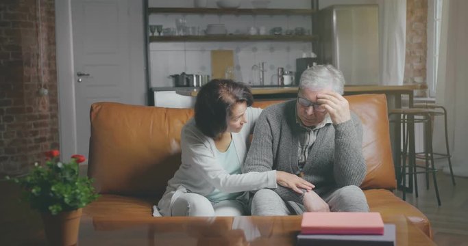Senior woman tries to comfort her disappointed husband