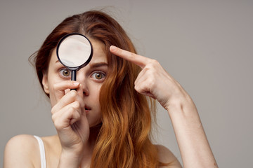 woman looking through a magnifying glass