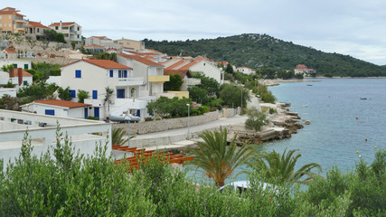 Fototapeta premium White houses with blue windows, coastal village in Greece