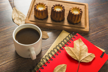 Notebooks and coffee near pastry