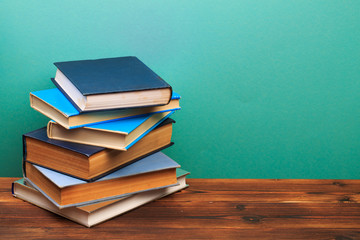  pile of old books, panorma, good copy space  on blue background