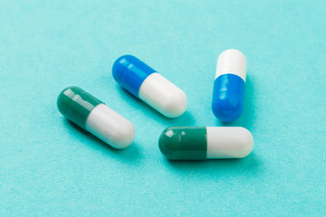 colour tablets and pills on blue background .