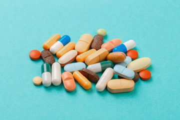 colour tablets and pills on blue background .