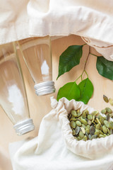 Glass bottle of water and green seeds