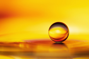 Marble on glass plate in yellow golden background