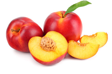 Nectarine with green leaf and slices isolated on white background