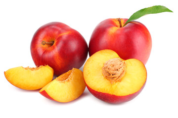Nectarine with green leaf and slices isolated on white background