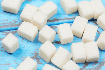 Group of refined white sugar cubes close up