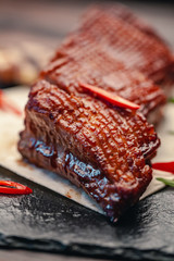 grilled beef steak with vegetables on gray slate background