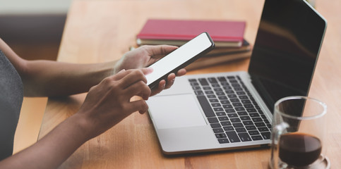 Close-up of female hand holding blank screen smartphone