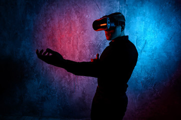 Fototapeta na wymiar Young man playing a virtual reality video game. Vr game with shotgun