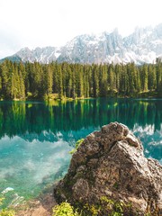 Karersee (Lago di Carezza), is a lake in the Dolomites in South Tyrol, a romantic beautiful place, azure pure water. Mountain summer landscape in the Dolomites in Northern Italy.