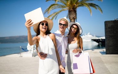 Happy young friends on luxury vacation. Travel, shopping, fun, friends concept