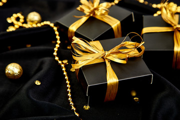 Luxury black gift boxes with gold ribbon