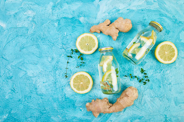 Fototapeta na wymiar Detox water in bottles with ingredients, ginger, lemon, mint