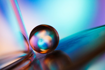 Small glass ball in abstract macro composition.