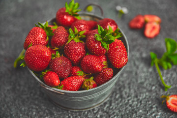 Ripe red strawberries on black table, Strawberries in white bowl. Fresh strawberries. grey strawberries. Diet food. Healthy, vegan. Top view. Flat lay. Copy space.