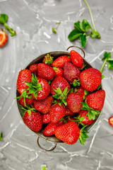 Ripe red strawberries on grey table, Strawberries in bowl. Fresh strawberries. Beautiful strawberries. Diet food. Healthy, vegan. Top view. Flat lay.