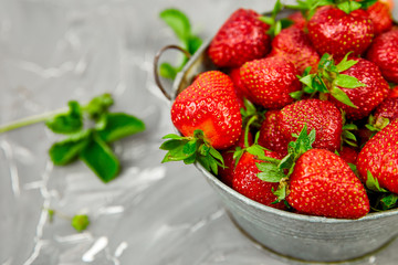 Ripe red strawberries on grey table, Strawberries in bowl. Fresh strawberries. Beautiful strawberries. Diet food. Healthy, vegan. Top view. Flat lay.