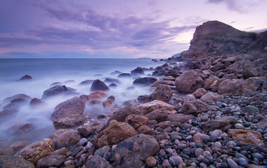 Waves, rocks and sunset at Crimia