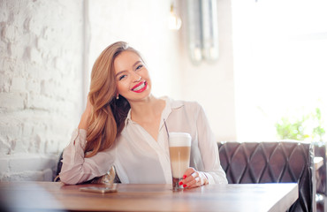 Young woman holding cup of coffee.
