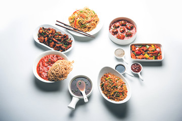 Assorted Indo chinese dishes in group includes Schezwan/Szechuan hakka noodles, veg fried rice, veg manchurian, american chop suey, chilli paneer, crispy vegetable and vegetable soup