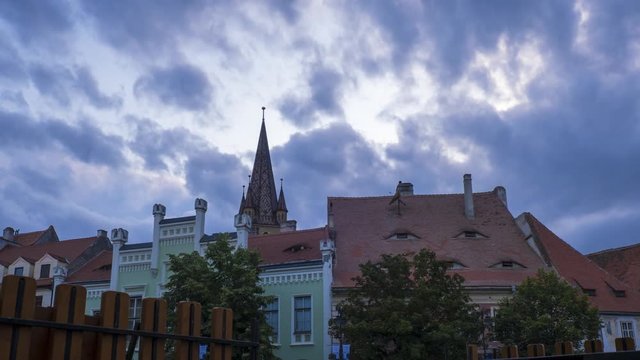 Time lapse: Dramatic storm clouds and sunset sky in the Small Square of Sibiu (Hermannstadt), Romania. Fixed angle, ProRes 422 VHQ, 4K.
