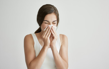 young woman blowing her nose