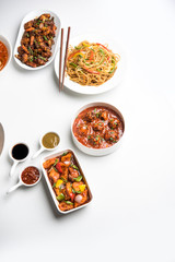 Assorted Indo chinese dishes in group includes Schezwan/Szechuan hakka noodles, veg fried rice, veg manchurian, american chop suey, chilli paneer, crispy vegetable and vegetable soup