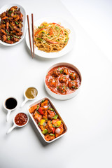 Assorted Indo chinese dishes in group includes Schezwan/Szechuan hakka noodles, veg fried rice, veg manchurian, american chop suey, chilli paneer, crispy vegetable and vegetable soup