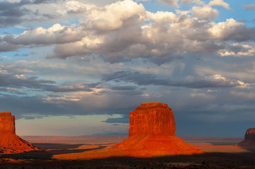 The famous Merrick and Mittens Buttes from monument valley basking in the Light of the setting sun.