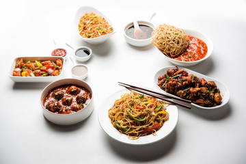 Assorted Indo chinese dishes in group includes Schezwan/Szechuan hakka noodles, veg fried rice, veg manchurian, american chop suey, chilli paneer, crispy vegetable and vegetable soup