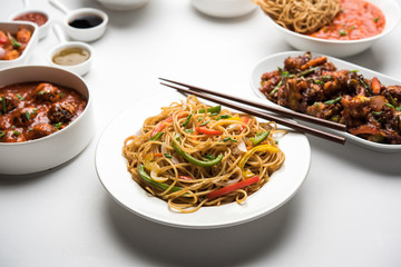 Assorted Indo chinese dishes in group includes Schezwan/Szechuan hakka noodles, veg fried rice, veg manchurian, american chop suey, chilli paneer, crispy vegetable and vegetable soup