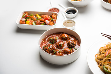Assorted Indo chinese dishes in group includes Schezwan/Szechuan hakka noodles, veg fried rice, veg manchurian, american chop suey, chilli paneer, crispy vegetable and vegetable soup