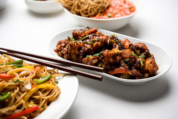 Assorted Indo chinese dishes in group includes Schezwan/Szechuan hakka noodles, veg fried rice, veg manchurian, american chop suey, chilli paneer, crispy vegetable and vegetable soup