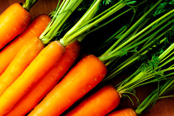 Detail fresh carrots with green petioles and leaves. Raw carrots full of vitamins ready for...