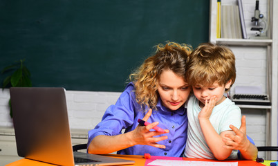 Back to school and home schooling. Mother helping son to make homework. Teachers day. Happy family. First time to school. Education for children.