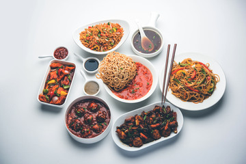 Assorted Indo chinese dishes in group includes Schezwan/Szechuan hakka noodles, veg fried rice, veg manchurian, american chop suey, chilli paneer, crispy vegetable and vegetable soup