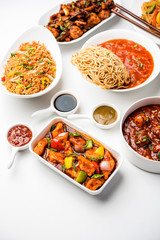 Assorted Indo chinese dishes in group includes Schezwan/Szechuan hakka noodles, veg fried rice, veg manchurian, american chop suey, chilli paneer, crispy vegetable and vegetable soup