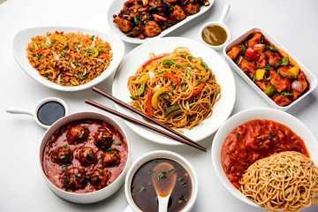 Assorted Indo chinese dishes in group includes Schezwan/Szechuan hakka noodles, veg fried rice, veg manchurian, american chop suey, chilli paneer, crispy vegetable and vegetable soup
