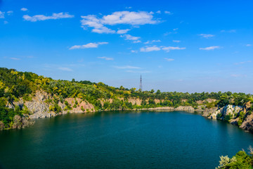 Fototapeta premium Beautiful lake in the abandoned granite quarry on summer