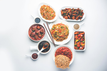 Assorted Indo chinese dishes in group includes Schezwan/Szechuan hakka noodles, veg fried rice, veg manchurian, american chop suey, chilli paneer, crispy vegetable and vegetable soup