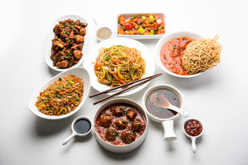 Assorted Indo chinese dishes in group includes Schezwan/Szechuan hakka noodles, veg fried rice, veg manchurian, american chop suey, chilli paneer, crispy vegetable and vegetable soup