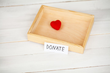 Donations and Charity. Donation Concept. Box of Donations and Heart on the White Background.