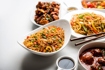 Assorted Indo chinese dishes in group includes Schezwan/Szechuan hakka noodles, veg fried rice, veg manchurian, american chop suey, chilli paneer, crispy vegetable and vegetable soup