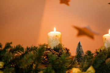 Christmas golden candles on the fireplace
