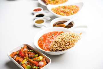 Assorted Indo chinese dishes in group includes Schezwan/Szechuan hakka noodles, veg fried rice, veg manchurian, american chop suey, chilli paneer, crispy vegetable and vegetable soup