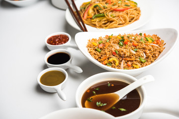 Assorted Indo chinese dishes in group includes Schezwan/Szechuan hakka noodles, veg fried rice, veg manchurian, american chop suey, chilli paneer, crispy vegetable and vegetable soup