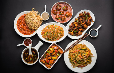 Assorted Indo chinese dishes in group includes Schezwan/Szechuan hakka noodles, veg fried rice, veg manchurian, american chop suey, chilli paneer, crispy vegetable and vegetable soup - obrazy, fototapety, plakaty